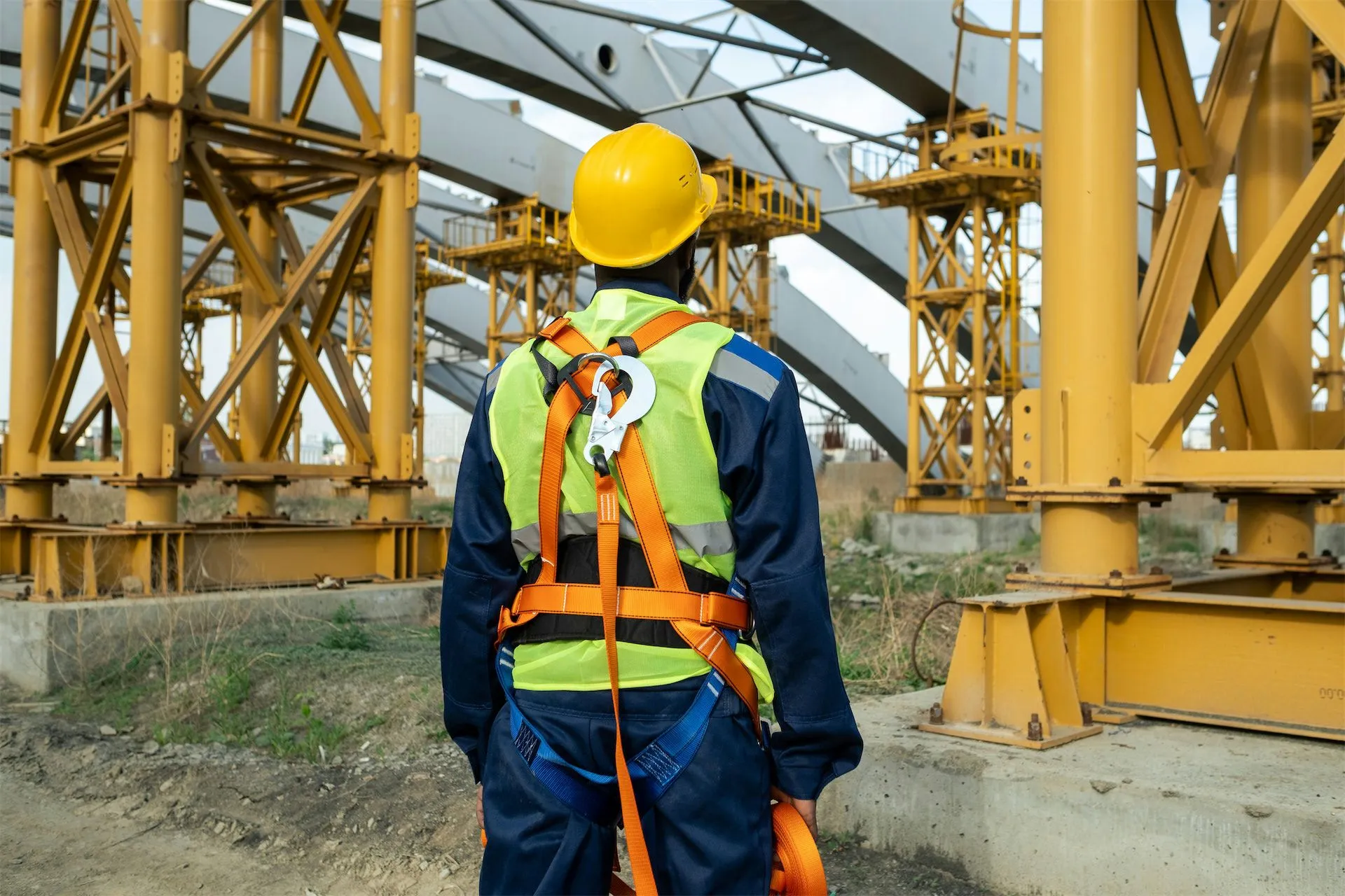 Construction professional wearing safety gear on an active job site.